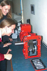 Final-year Matie Mechatronic Engineering students Marié Cilliers (back) and Jeanne-Marie Venter inspect one of the gearboxes donated by SEW Eurodrive